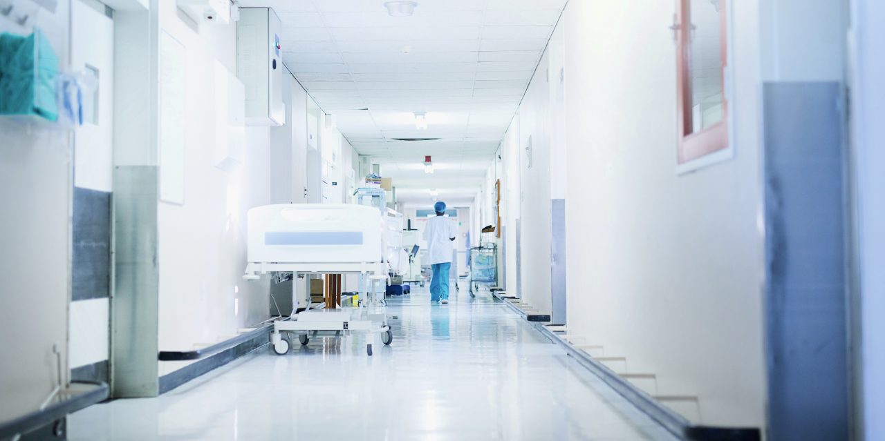 Rearview shot of a surgeon walking down a hospital corridor